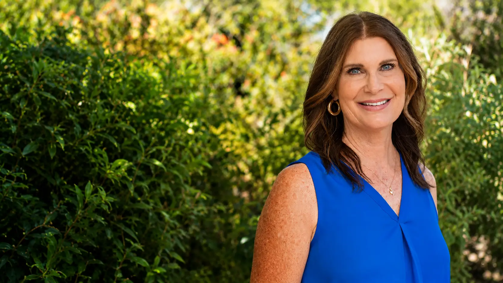Amanda from A Senior Journey, smiling outdoors in Tucson
